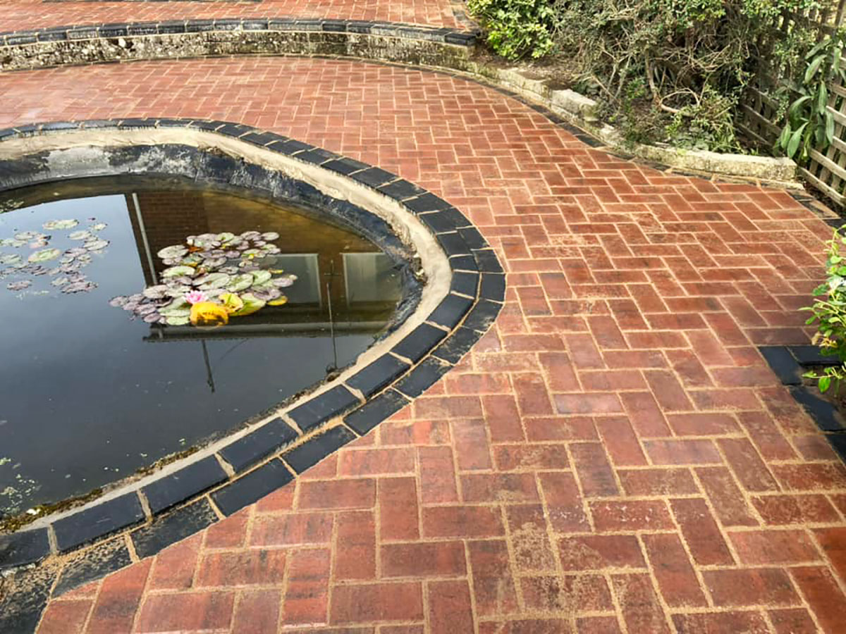 Natural stone patio installation around water feature